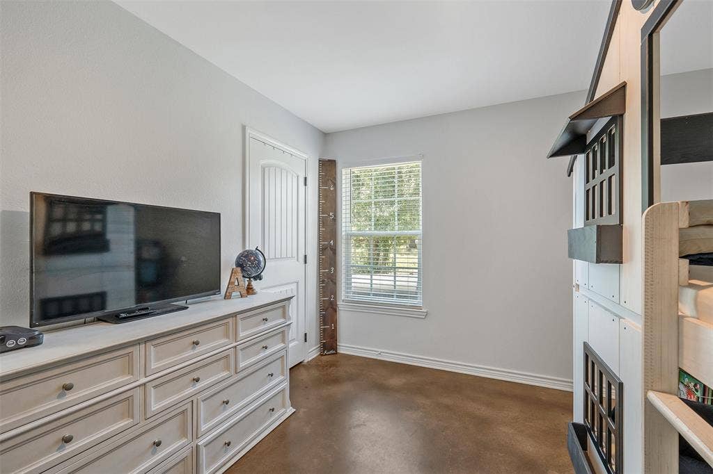 19731 County Road 4130, Lindale, TX 75771 Neutral wall paint, wood-finish flooring, white trim, and a white paneled door