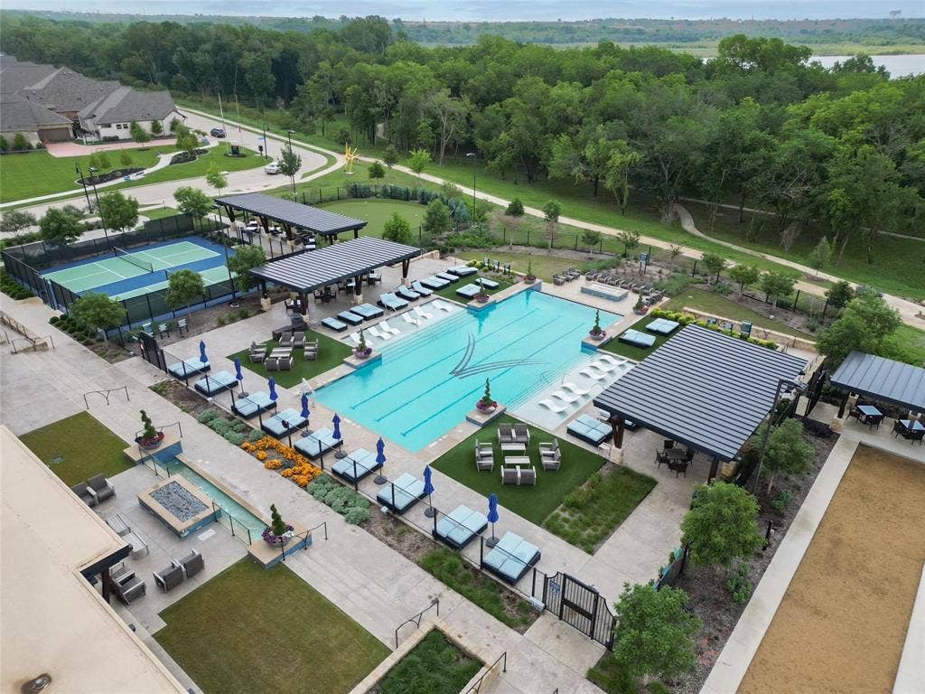 1416 White Squall Trail, Arlington, TX 76005 Resort-style amenities featuring a large outdoor pool, tennis court, bocce ball court, covered outdoor lounge areas, and a linear fire feature