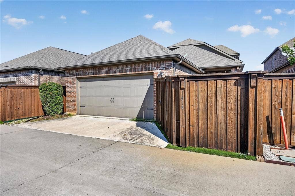 1416 White Squall Trail, Arlington, TX 76005 Brick exterior with a two-car garage and wood privacy fencing
