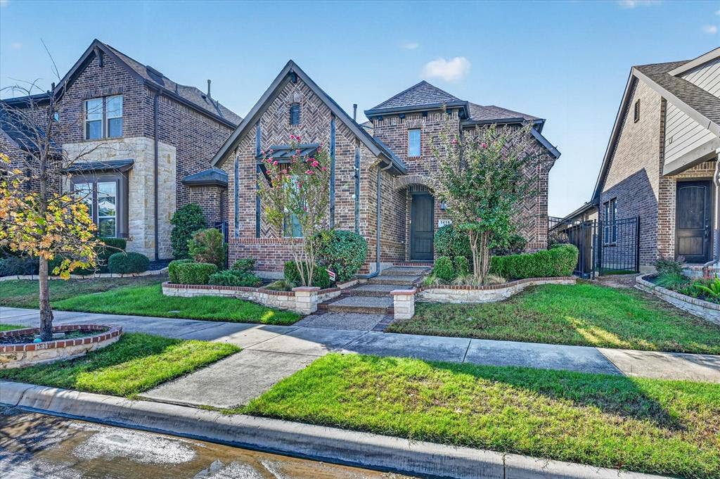 1416 White Squall Trail, Arlington, TX 76005 Brick exterior with stone accents, arched entry, mature landscaping, and an integrated garage