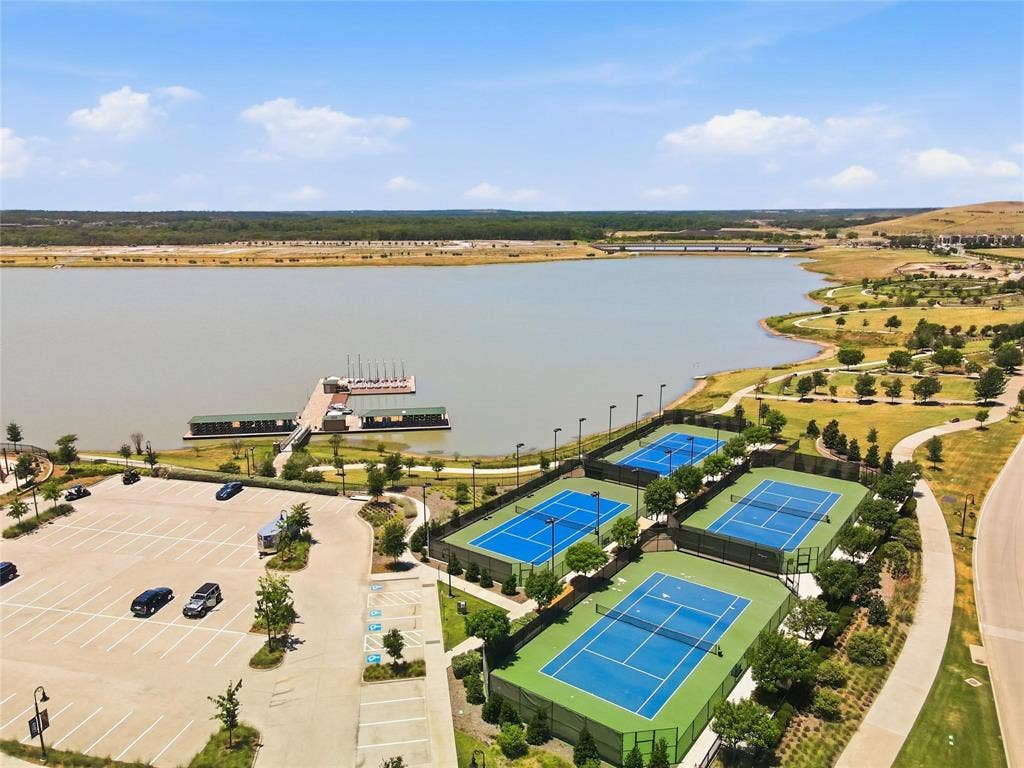 1416 White Squall Trail, Arlington, TX 76005 Expansive lakefront with a large dock, multiple tennis courts, and paved pathways