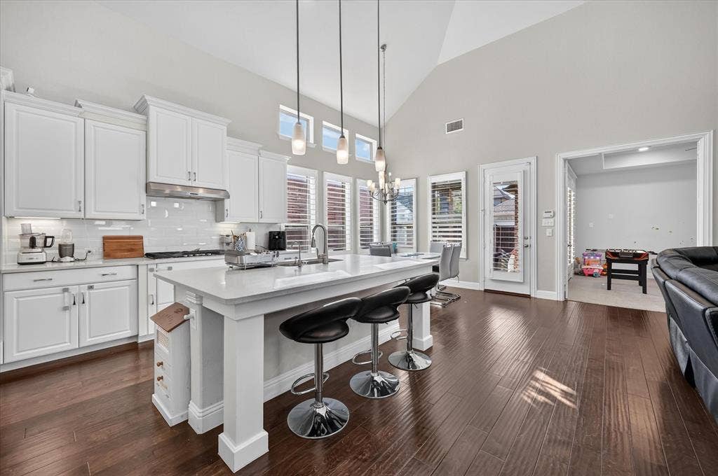 1416 White Squall Trail, Arlington, TX 76005 Spacious kitchen featuring white cabinetry, a large center island, and wood-finish flooring
