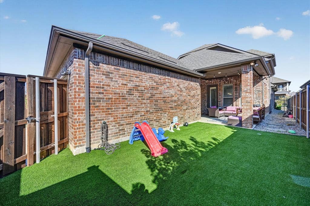 1416 White Squall Trail, Arlington, TX 76005 Brick exterior, fenced yard, covered patio, artificial turf, wood fence
