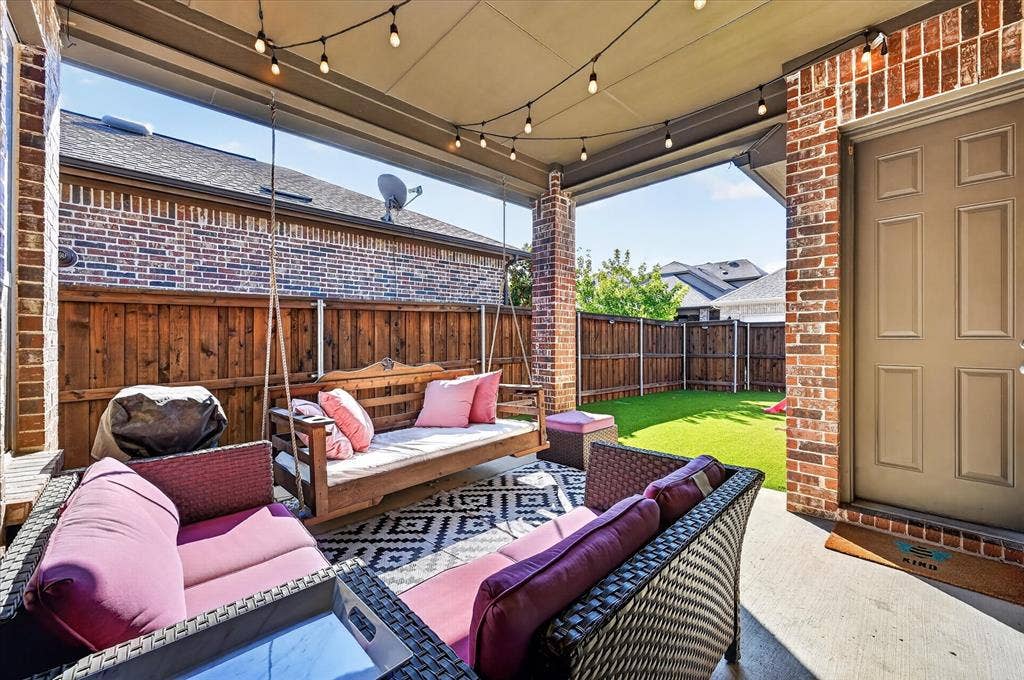 1416 White Squall Trail, Arlington, TX 76005 Covered patio with string lighting, concrete flooring, and brick columns