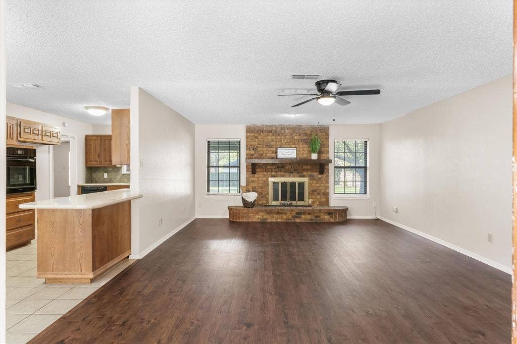 Large brick wood burning fireplace with a raised hearth