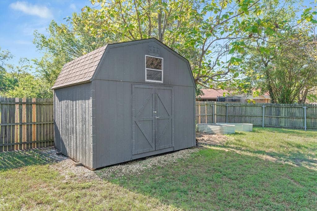 Raised bed garden area and a 12x12 storage building with loft area and workbench