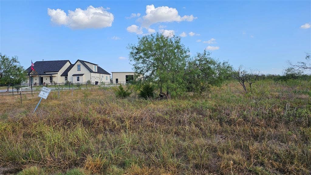 000 FM-1392, Terrell, TX 75160 Neighboring custom-built home to the left of the property looking east.