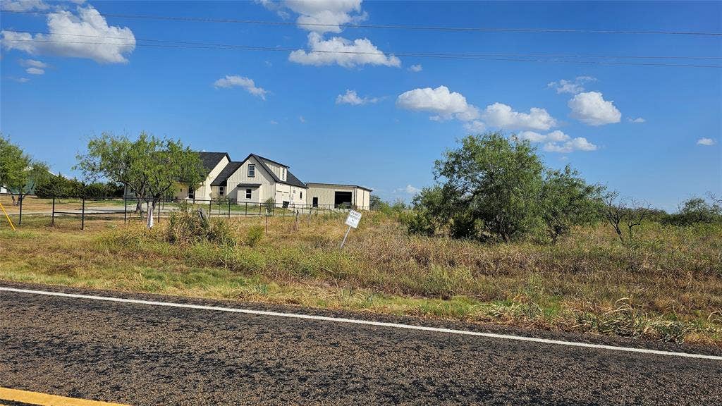 000 FM-1392, Terrell, TX 75160 View from the road looking east with neighboring custom-built home.