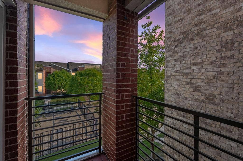 Private balcony with metal railings and brick columns