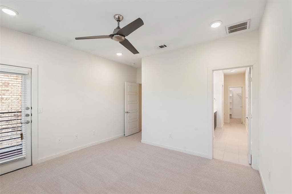 Neutral-toned carpeting, recessed lighting, and a contemporary ceiling fan
