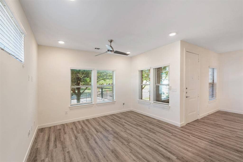 Wood-finish flooring throughout, recessed lighting, and a contemporary ceiling fan