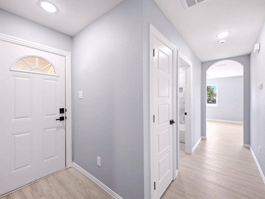 1727 Mentor Avenue, Dallas, TX 75216 Recessed ceiling lighting, light wood-finish flooring, arched doorway, paneled interior doors, and front door with decorative glass insert
