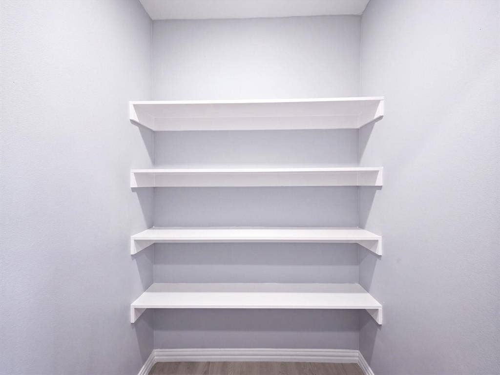 1727 Mentor Avenue, Dallas, TX 75216 Built-in white shelving, wood-finish flooring