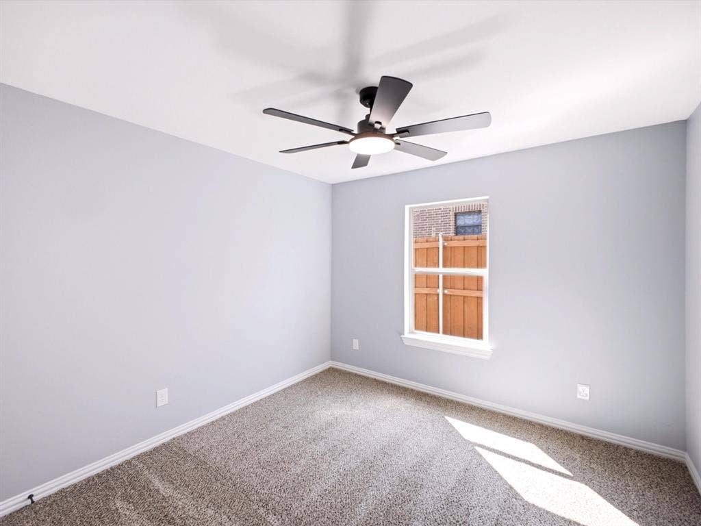 1727 Mentor Avenue, Dallas, TX 75216 Carpeted room with a single window and a ceiling fan with integrated lighting