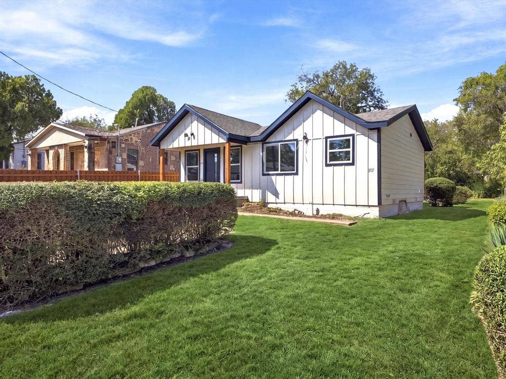 1727 Mentor Avenue, Dallas, TX 75216 White exterior with dark trim accents, covered entry with wood posts, front yard with manicured lawn, and mature hedges