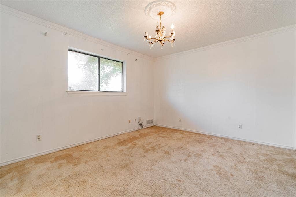 4320 Hickox Road, Rowlett, TX 75089 Crown molding and a decorative ceiling medallion complement the overhead chandelier