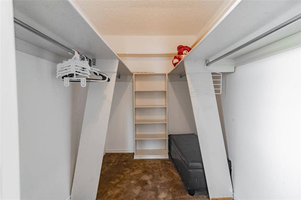 4320 Hickox Road, Rowlett, TX 75089 Built-in shelving unit, dual clothing rods, and white painted walls
