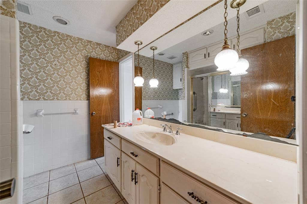 4320 Hickox Road, Rowlett, TX 75089 Integrated vanity with single basin, tile flooring, and a shower enclosure