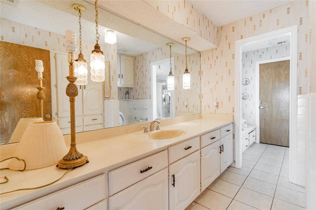 4320 Hickox Road, Rowlett, TX 75089 Vanity with an integrated sink, full-width mirror, and pendant lighting