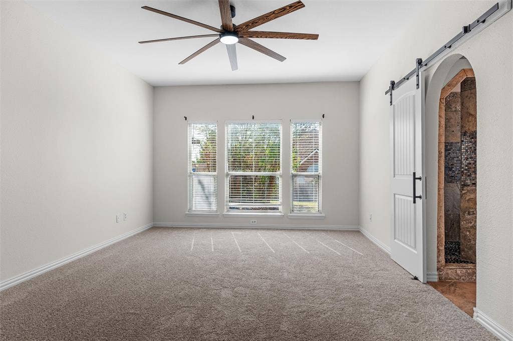 Neutral-toned carpeted flooring complements the light wall color