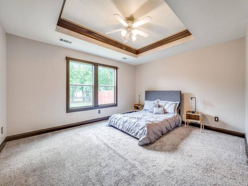 5604 Parkplace Drive, Denton, TX 76226 Tray ceiling with decorative molding and a ceiling fan