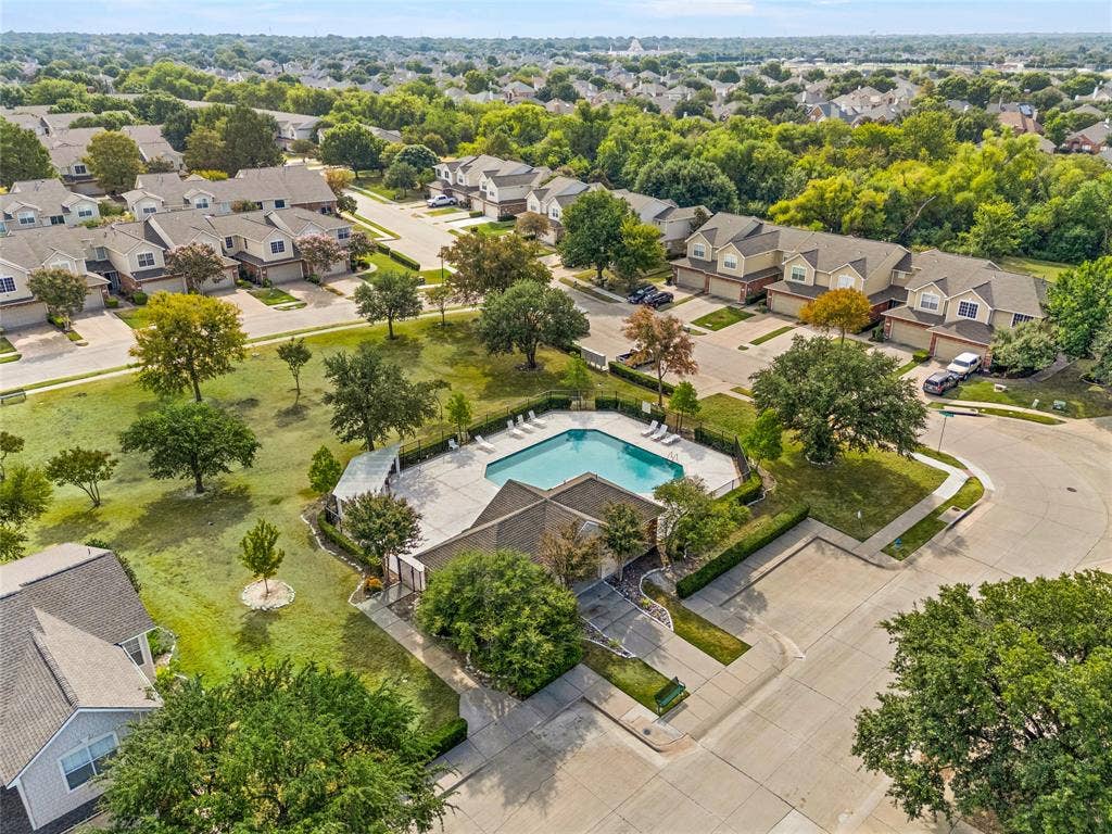4535 Woodsboro Lane, Plano, TX 75024 Community pool with surrounding patio, mature trees, and landscaping