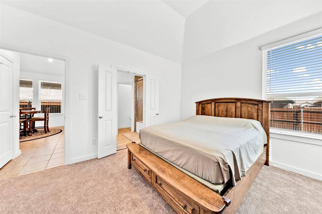 3928 Bison Lane, Crandall, TX 75114 Vaulted ceiling, neutral carpet flooring, and a large window with blinds