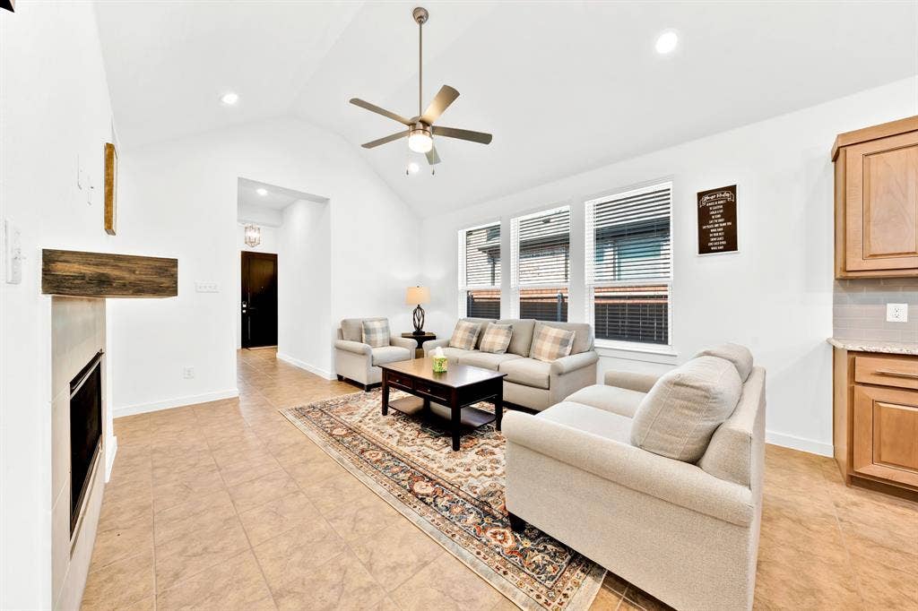 3928 Bison Lane, Crandall, TX 75114 Vaulted ceiling with a ceiling fan, recessed lighting, tile flooring, built-in fireplace, and kitchen cabinetry with a countertop