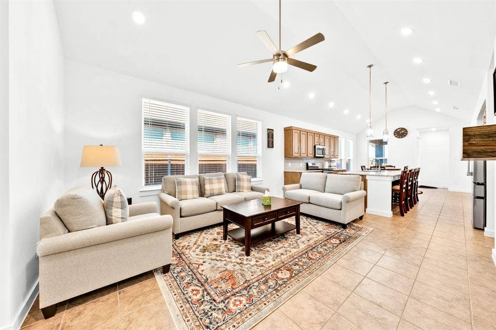 3928 Bison Lane, Crandall, TX 75114 Vaulted ceilings with recessed lighting, ceiling fan, tile flooring, and a kitchen island with pendant lighting