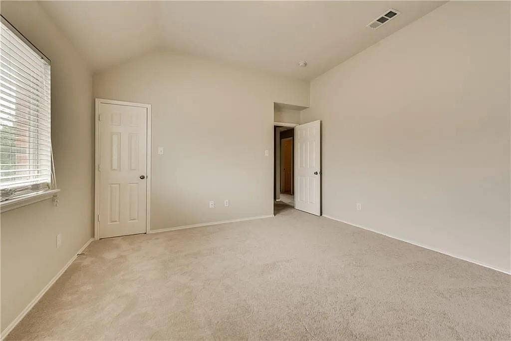9304 Regal Oaks Drive, McKinney, TX 75072 Vaulted ceiling, neutral wall paint, light-colored carpet flooring, window with blinds, panel doors