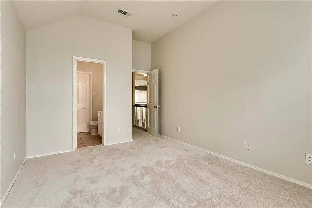 9304 Regal Oaks Drive, McKinney, TX 75072 Vaulted ceiling, neutral wall tones, carpeted flooring, recessed lighting, and a white six-panel door