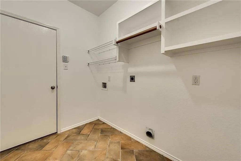 9304 Regal Oaks Drive, McKinney, TX 75072 Built-in shelving, hanging rod, wall-mounted drying rack, utility hookups, and a privacy door