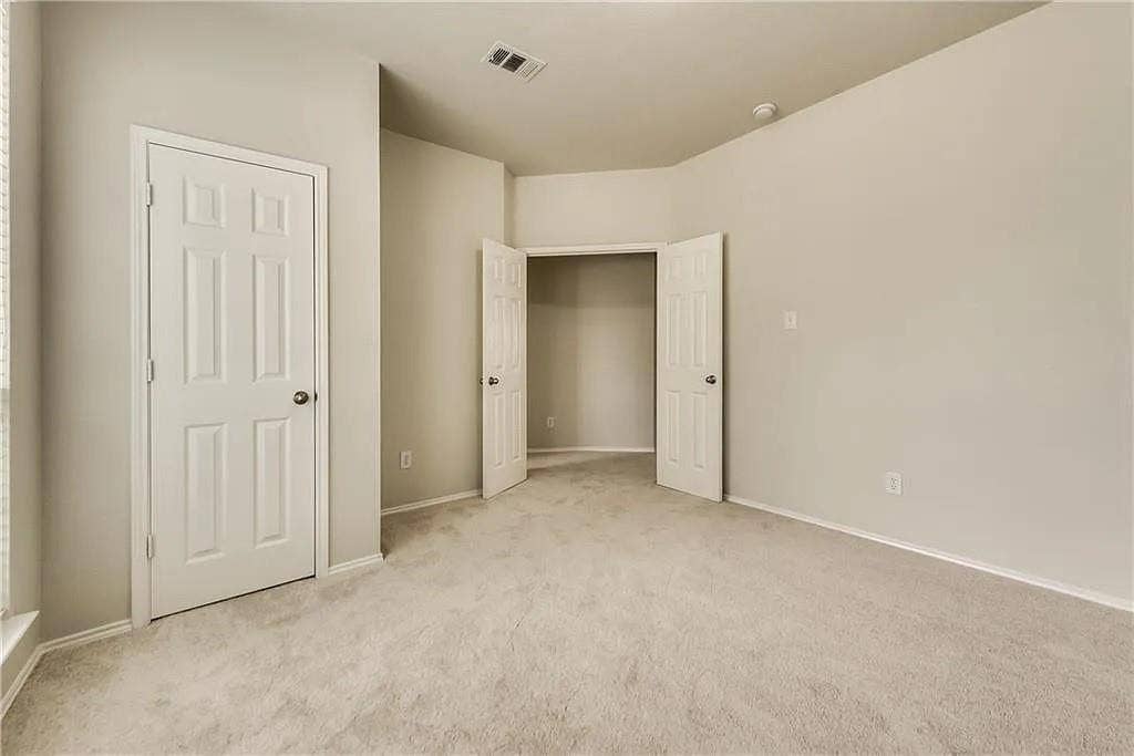 9304 Regal Oaks Drive, McKinney, TX 75072 Neutral wall paint, plush carpet flooring, paneled interior doors, and a built-in closet space