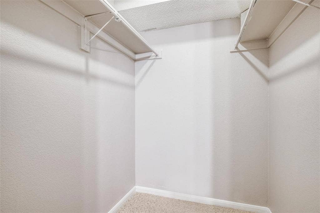6108 Abrams Road, #118, Dallas, TX 75231 U-shaped closet with wire shelving and a carpeted floor