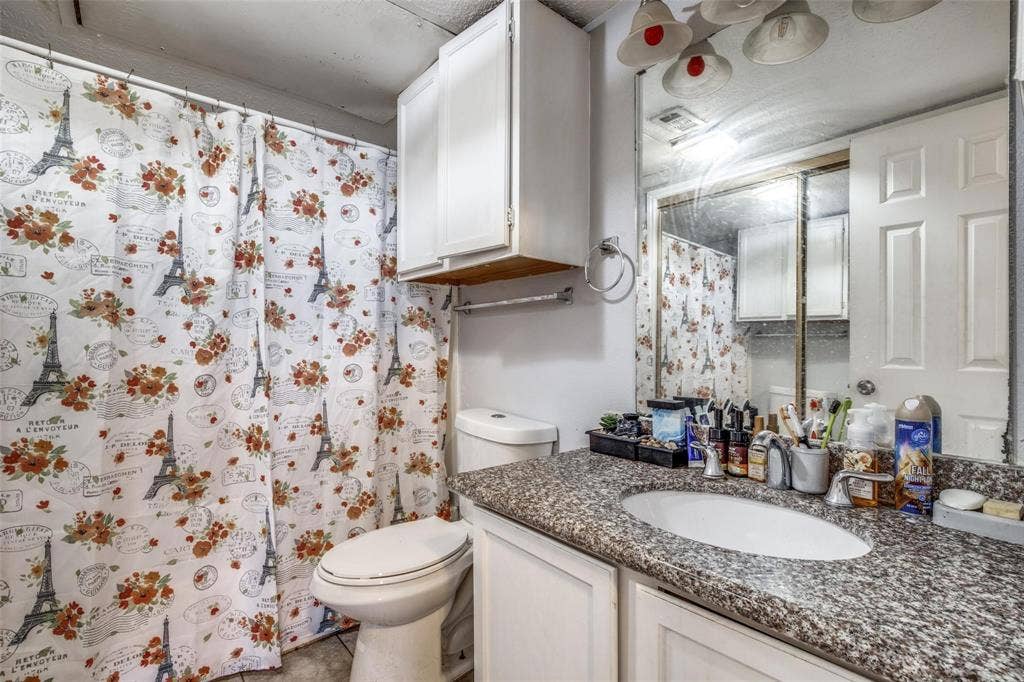 6108 Abrams Road, #118, Dallas, TX 75231 Vanity with a granite-look countertop and an integrated oval sink
