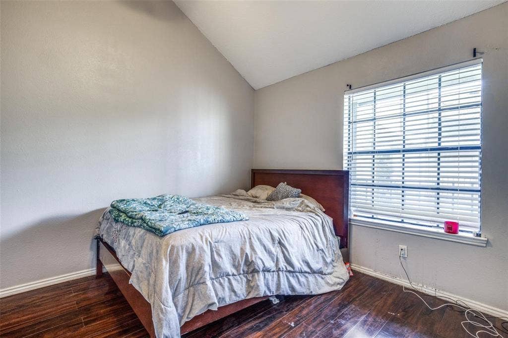 6108 Abrams Road, #118, Dallas, TX 75231 Vaulted ceiling, wood-finish flooring, and a large window with horizontal blinds