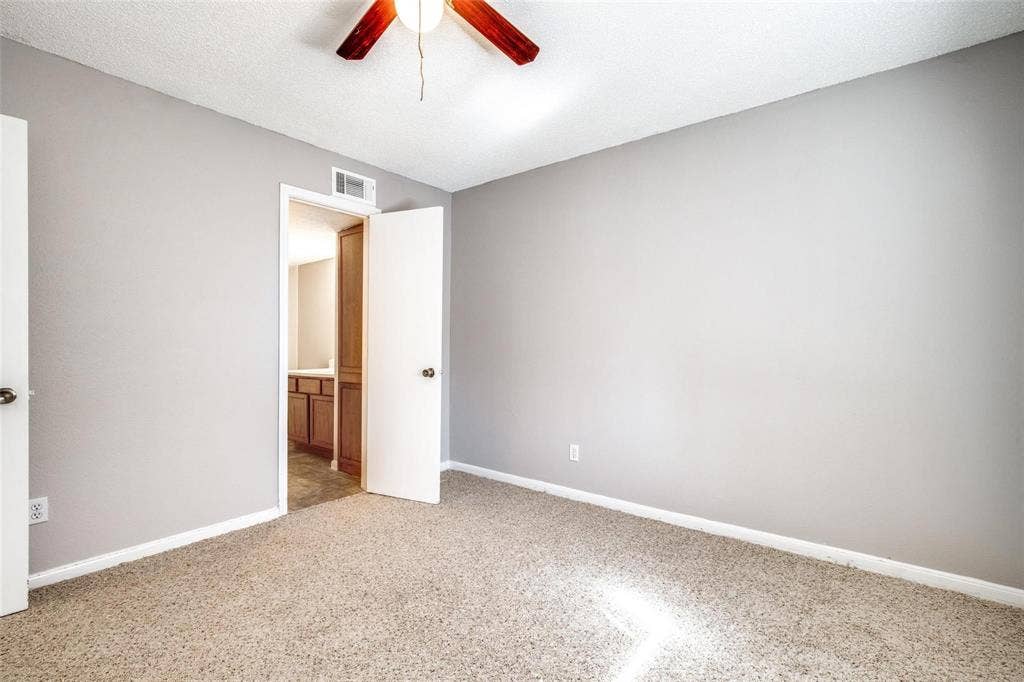 6108 Abrams Road, #118, Dallas, TX 75231 Carpeted flooring, neutral wall paint, ceiling fan, solid core door, wood-finish cabinetry