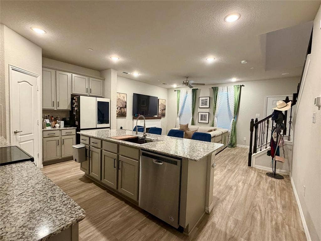 2812 Appaloosa Lane, Mesquite, TX 75150 Kitchen island with integrated sink, stainless steel dishwasher, and granite countertops