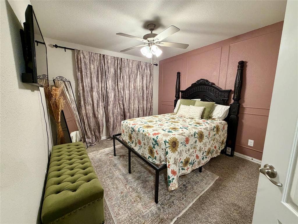 2812 Appaloosa Lane, Mesquite, TX 75150 Recessed wall paneling, ceiling fan with integrated lighting, wall-mounted television, and neutral carpet flooring