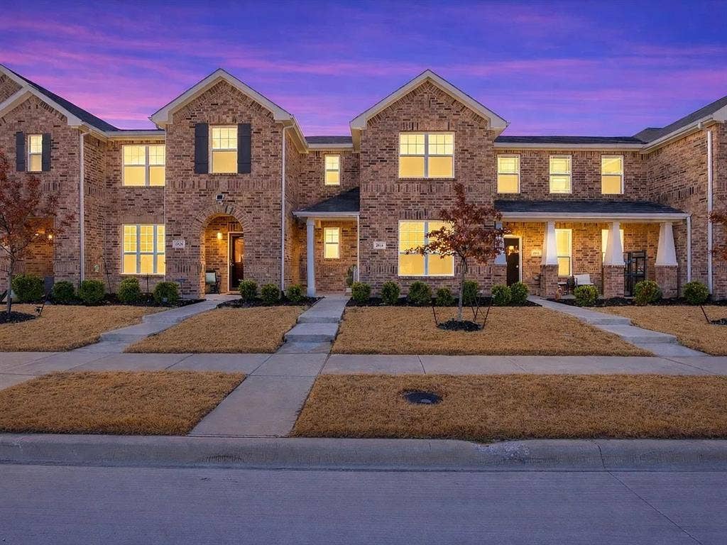 2812 Appaloosa Lane, Mesquite, TX 75150 Brick exterior construction, arched entryway, covered porch, multiple windows with dark shutters, paved walkways