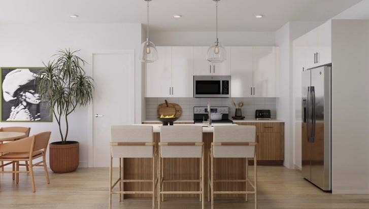 9801 Plainfield Drive, #WW9807, Fort Worth, TX 76108 Kitchen featuring tasteful backsplash, light countertops, appliances with stainless steel finishes, hanging light fixtures, and a kitchen island with sink
