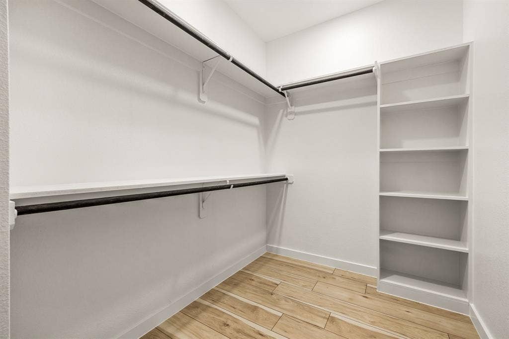 2232 Hooper Street, Dallas, TX 75215 Built-in closet shelving, multiple hanging rods, durable wood-finish flooring, recessed lighting, and white wall finishes
