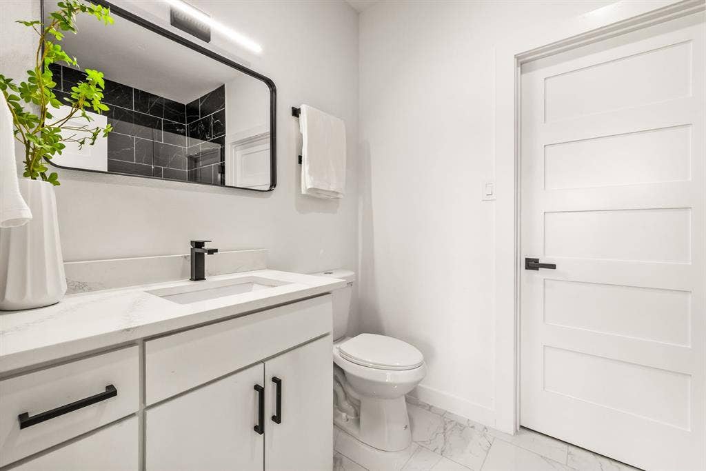2232 Hooper Street, Dallas, TX 75215 White vanity with a built-in rectangular sink, matte black faucet, and white countertop
