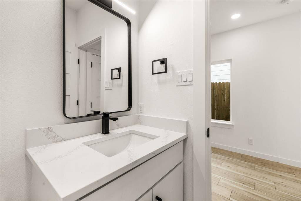 2232 Hooper Street, Dallas, TX 75215 Vanity with a rectangular sink, matte black faucet, and white countertop