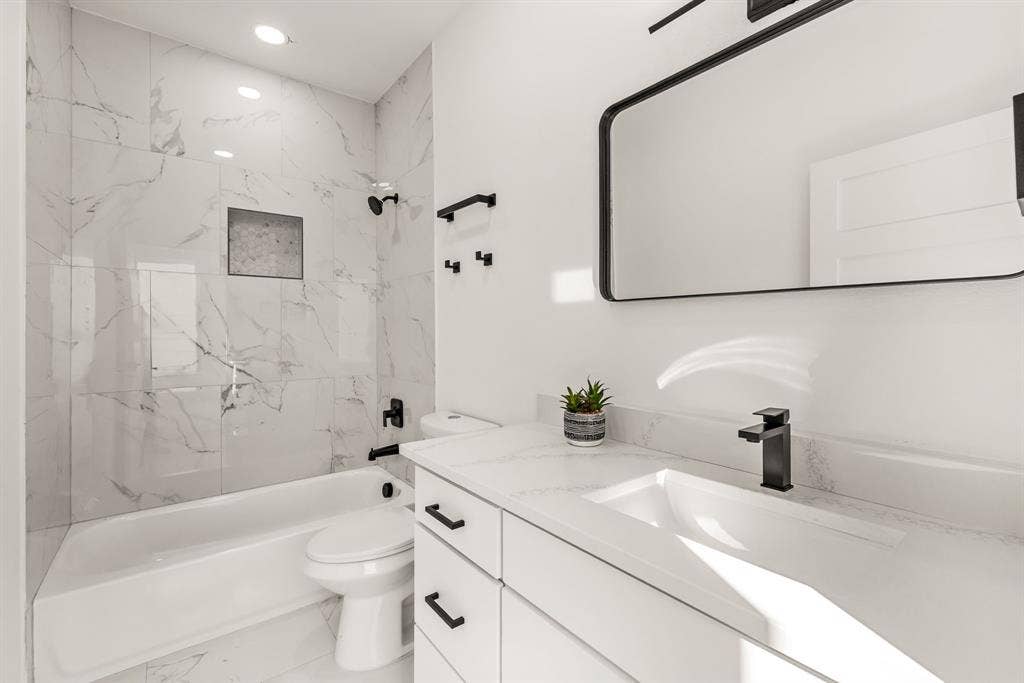 2232 Hooper Street, Dallas, TX 75215 Bathroom featuring a white vanity with an integrated rectangular sink, matte black faucet, and white countertop