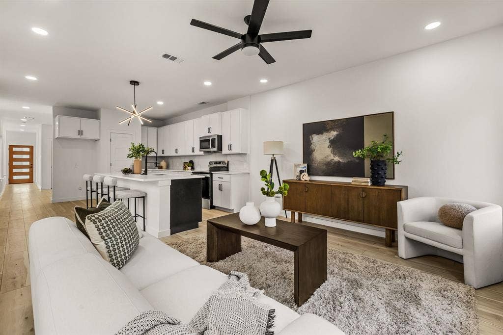 2232 Hooper Street, Dallas, TX 75215 Bright open-concept living area featuring wood-finish flooring, recessed lighting, and a contemporary ceiling fan