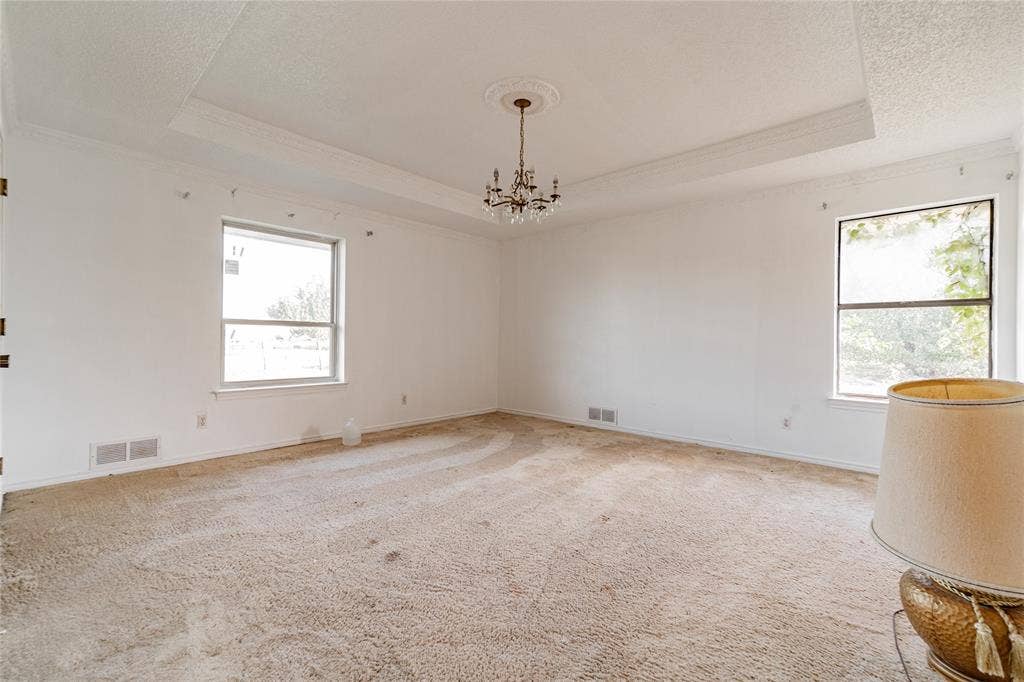 4320 Hickox Road, Rowlett, TX 75089 Tray ceiling with crown molding, decorative ceiling medallion, and a chandelier