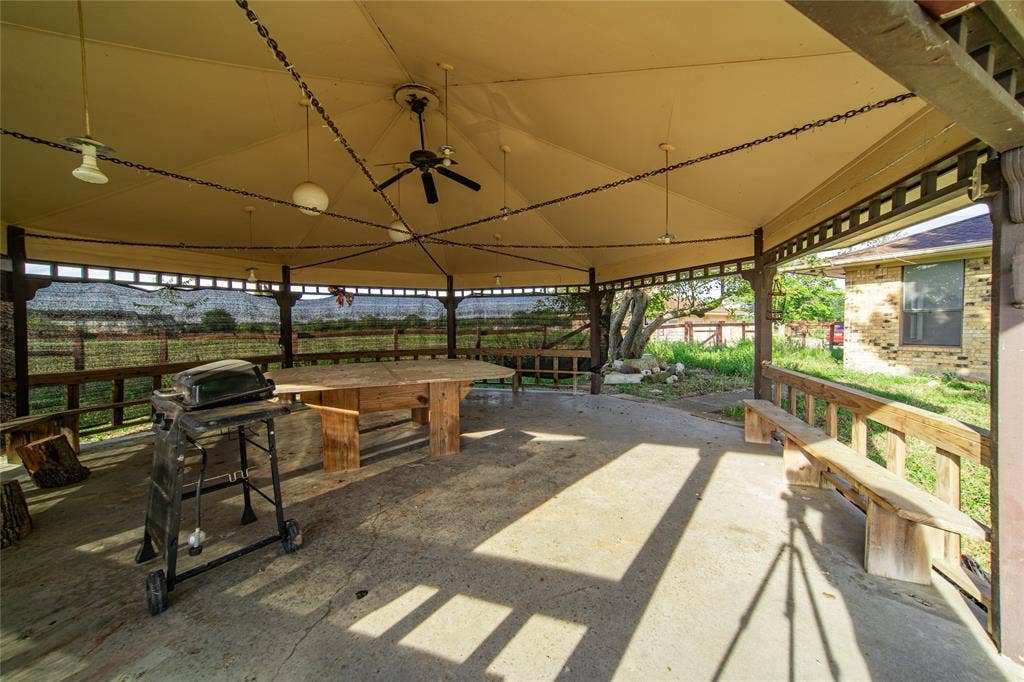 4320 Hickox Road, Rowlett, TX 75089 Covered outdoor pavilion with concrete flooring, wood perimeter railing, and a canvas roof