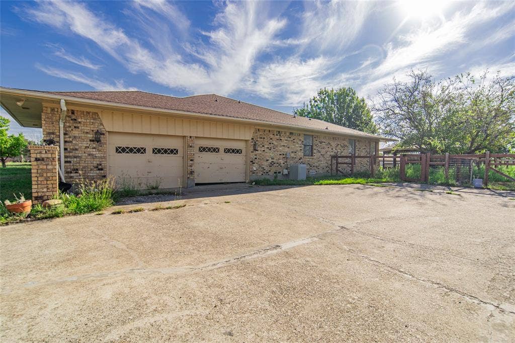 4320 Hickox Road, Rowlett, TX 75089 Brick exterior with a shingle roof and a two-car garage