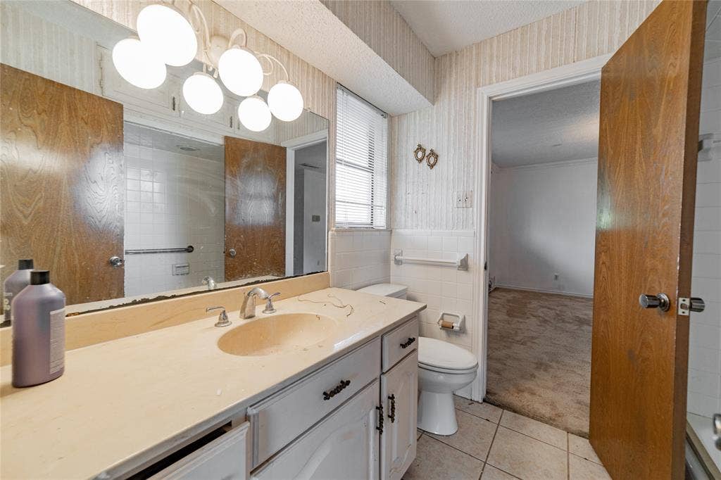 4320 Hickox Road, Rowlett, TX 75089 Vanity with integrated sink, chrome faucet, and white cabinetry